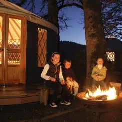Happy yurt camper kids by the fire