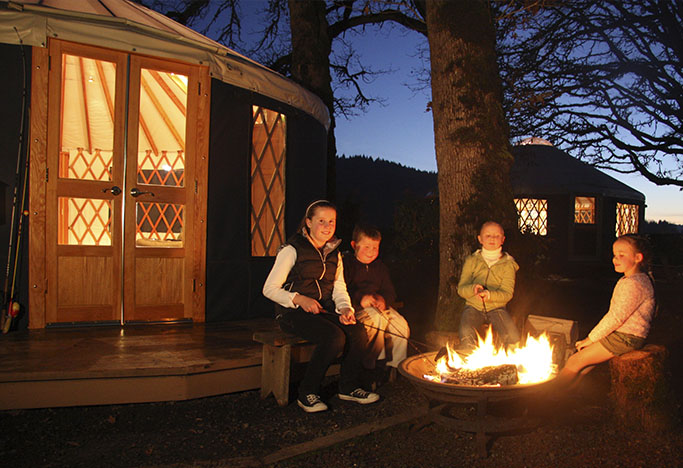 Happy yurt camper kids by the fire