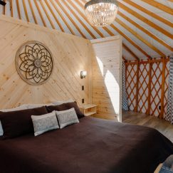 Queen bed inside a Pacific Yurt.