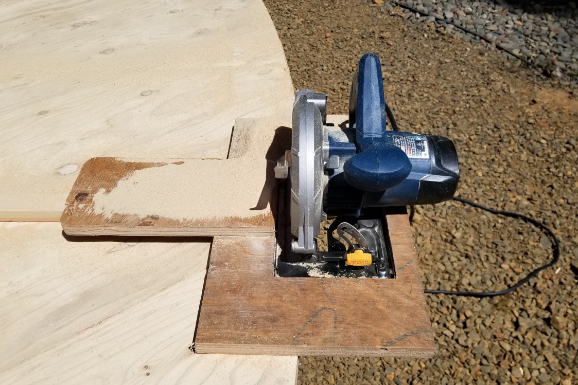 Hand saw cutting a yurt platform floor.