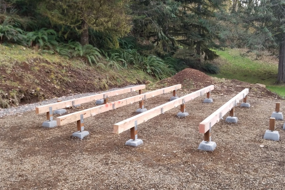 Yurt platform footings laying in a row.