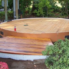 Wooden yurt platform and front steps.