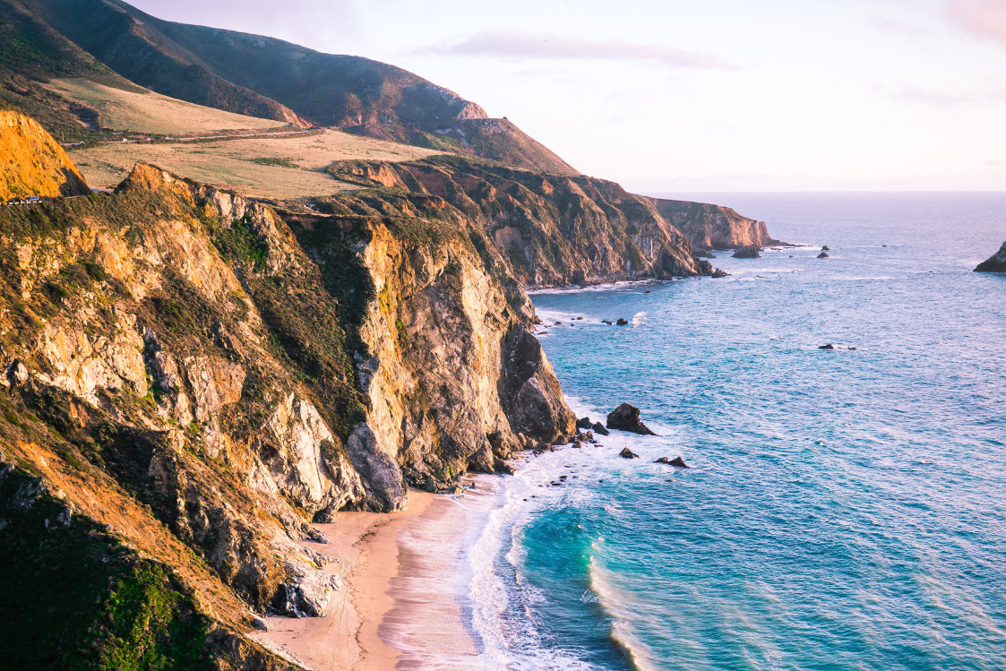 Ocean view of cliffs and a beach in Central California.