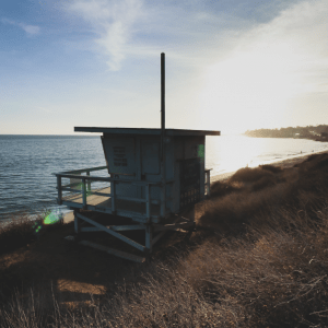 Lifeguard lookout post on a sand dune facing the ocean.