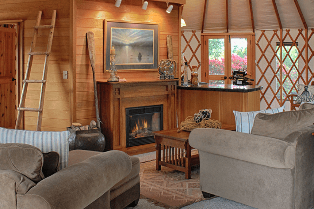 interior of yurt with warm fireplace and sofa