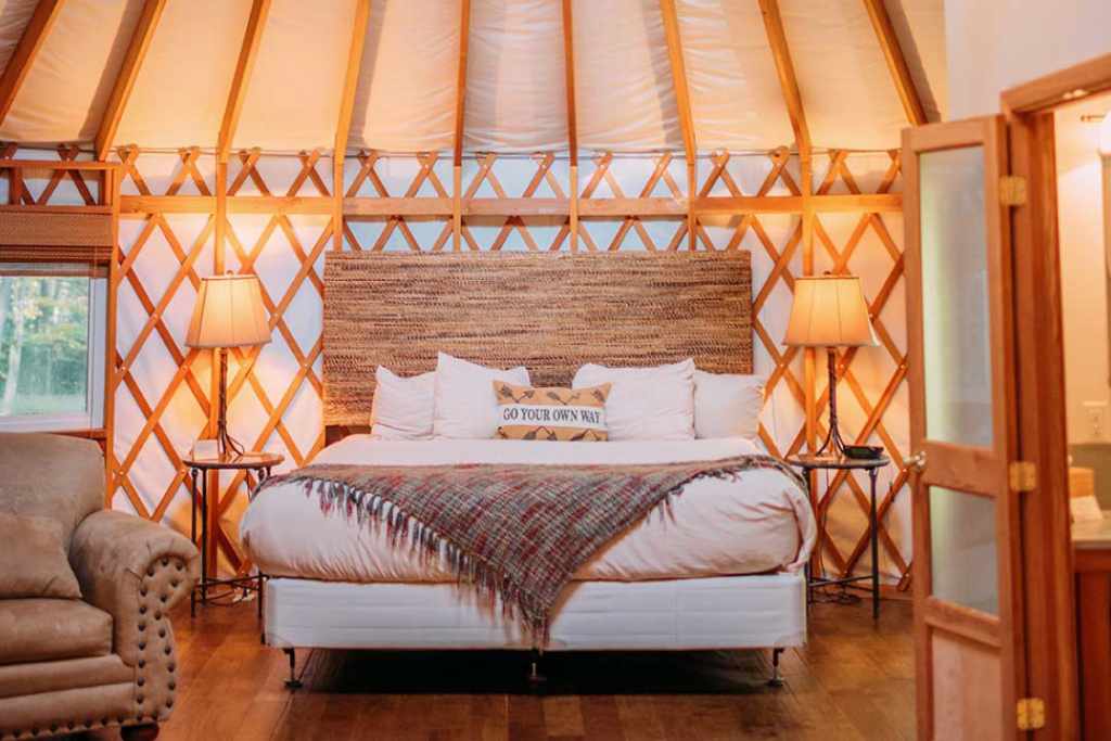 interior of yurt with large bed and frame
