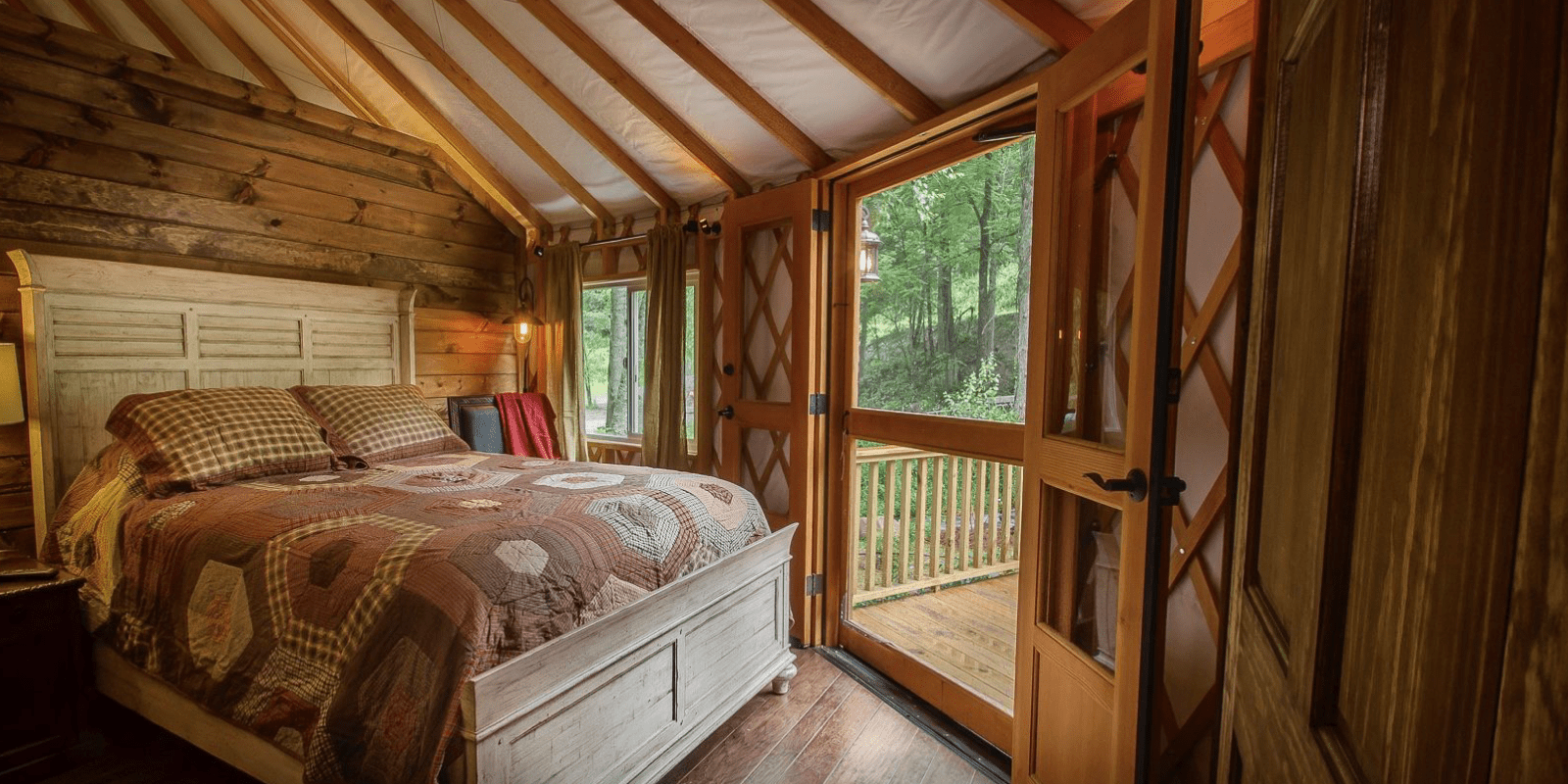 interior of yurt with wood features and bed frame