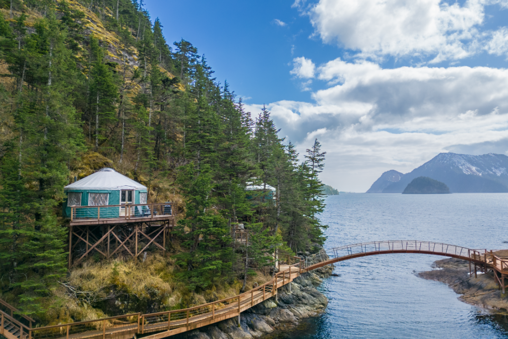 Pacific Yurt on Orca Island with a wooden walk way on the shore.
