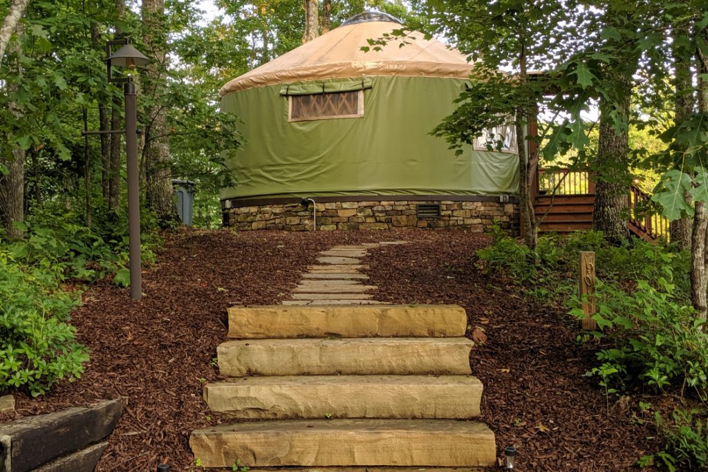 pacific yurt sitting at top of a hill next to staircase