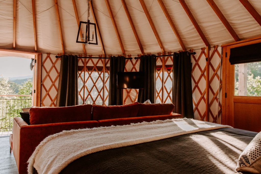 inside of yurt with queen bed.