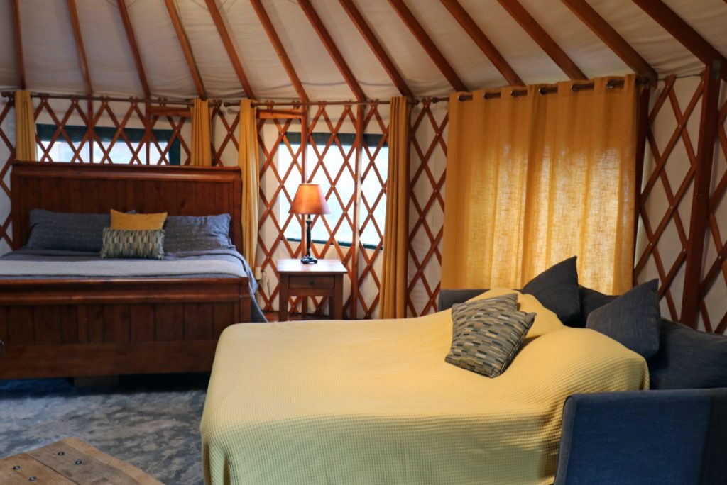 bedroom inside yurt with two beds.