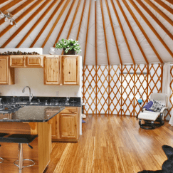 Small kitchen in a Pacific Yurt with an island with high-chair seating.