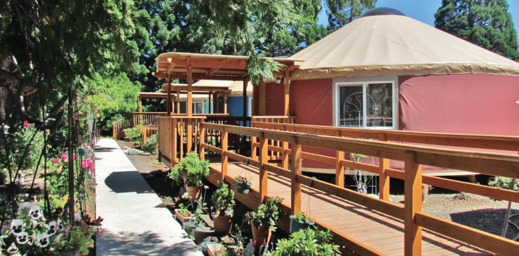 header-design-perfect-yurt - Pacific Yurts Exterior of yurt in nature park.